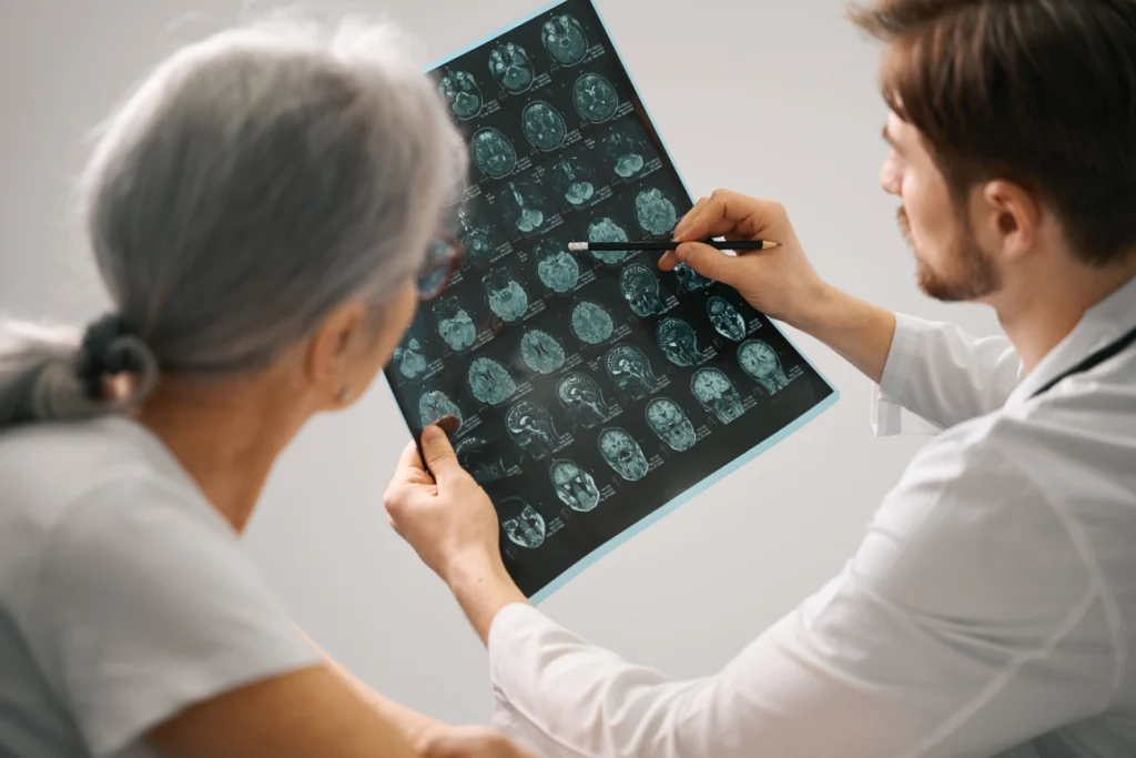 Doctor explaining brain scan results to an elderly patient during a medical consultation